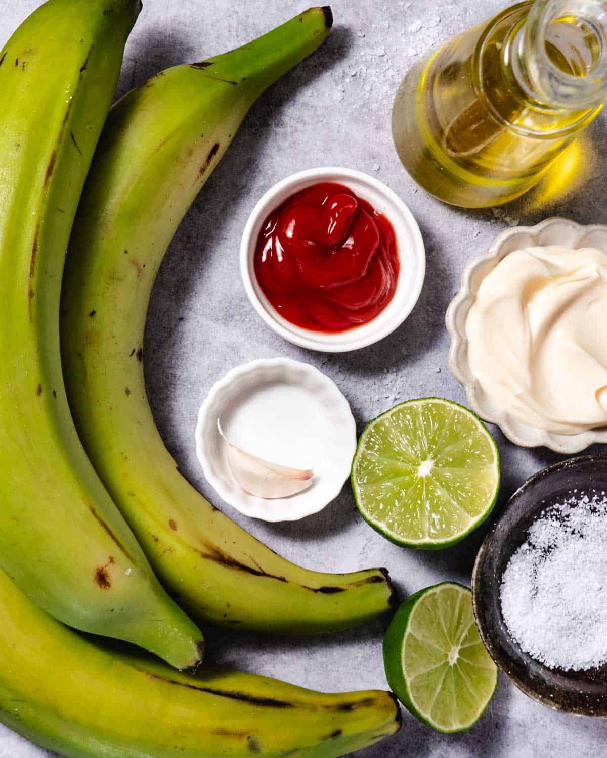 tostones ingredients including plantains, lime, oil, ketchup, mayo, garlic, and salt