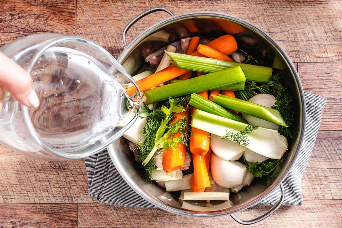 Homemade chicken soup ingredients in a pot.