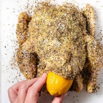 inserting a pierced lemon into the cavity of a chicken before roasting