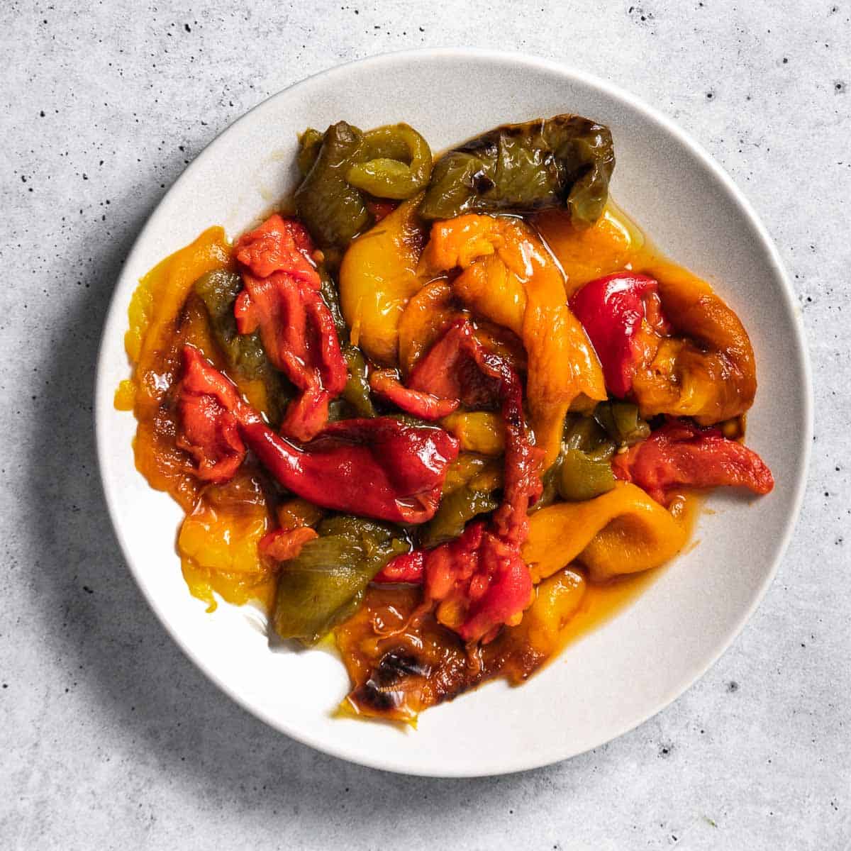 Roasted peppers on a white plate.