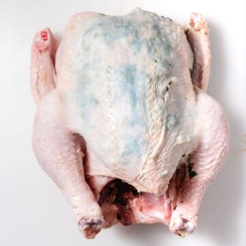 chicken with garlic and basil under the skin before roasting