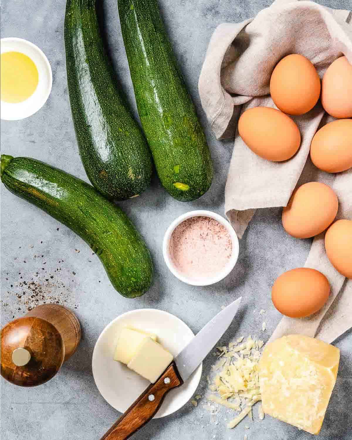 Zucchini eggs, cheese, and butter for zucchini frittata.