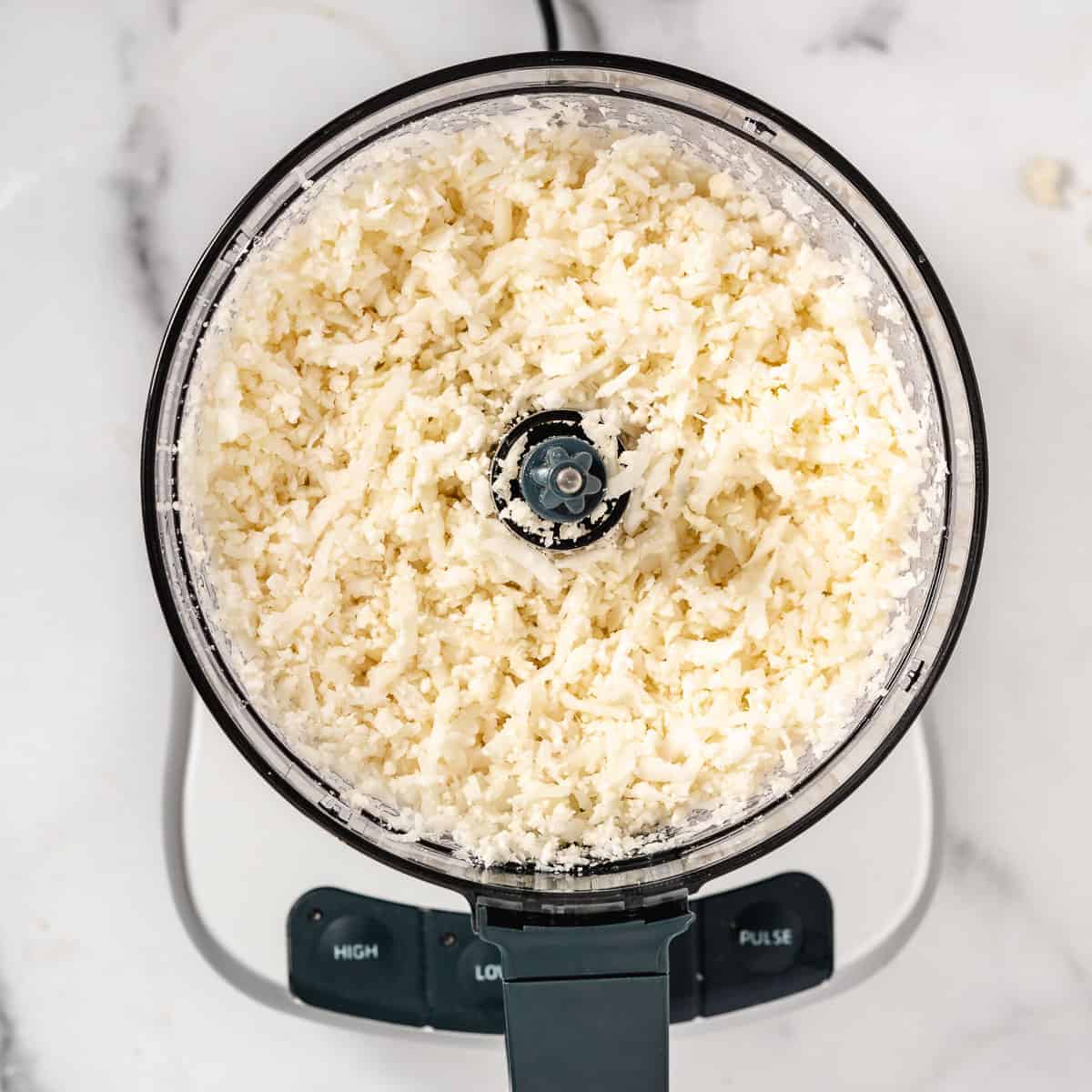 cauliflower rice being shredded.