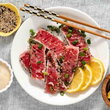 Seared tuna with sesame sauce on a plate.