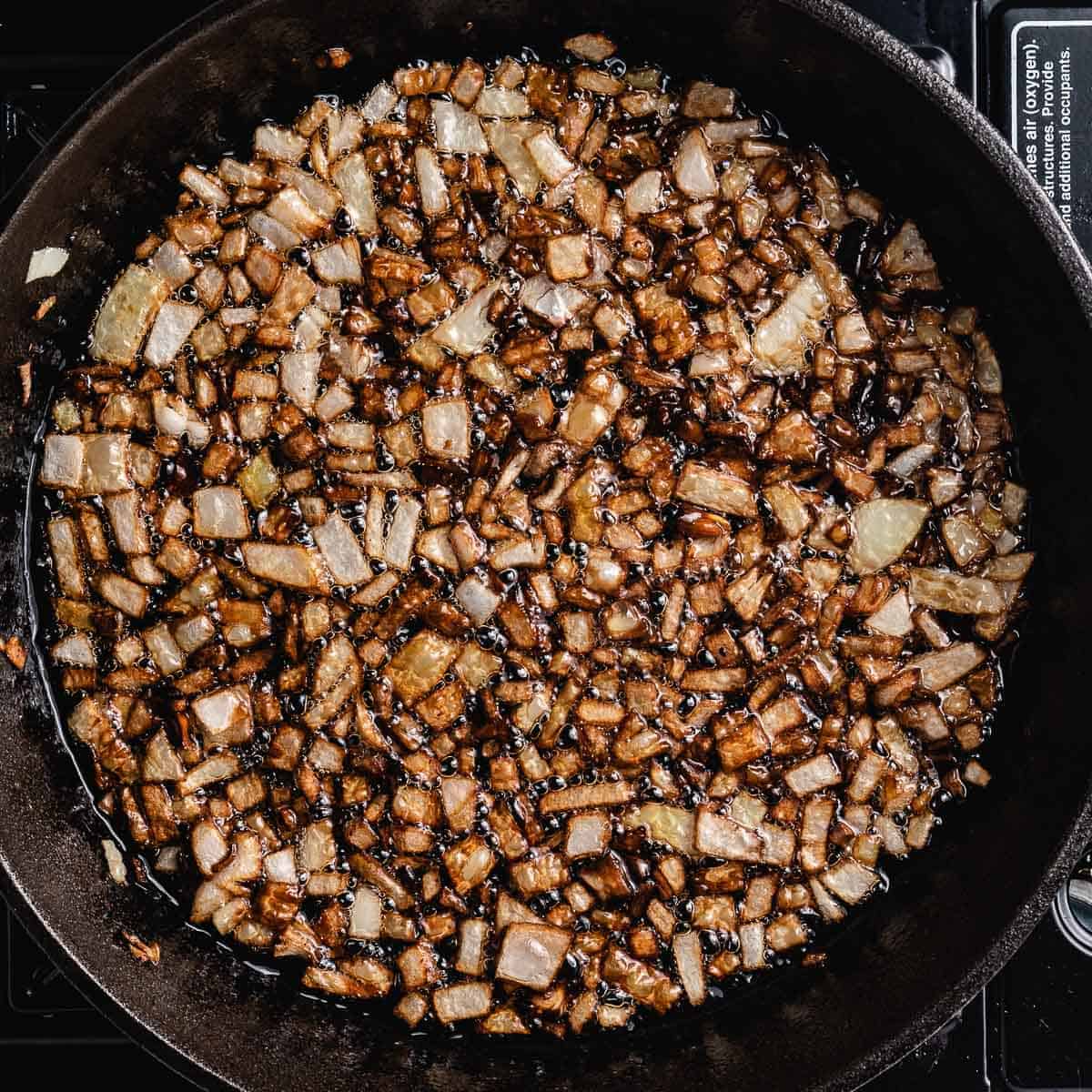 Frying onions in cast iron pan.