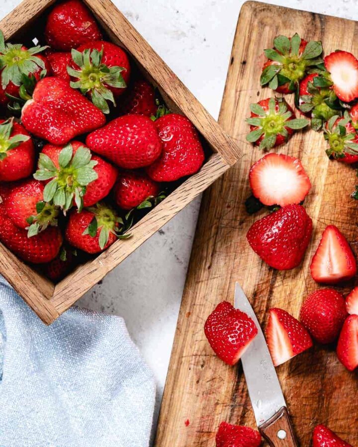 strawberries in basket and cutting board