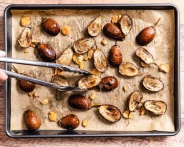 Roasting baby eggplant on a sheet pan.
