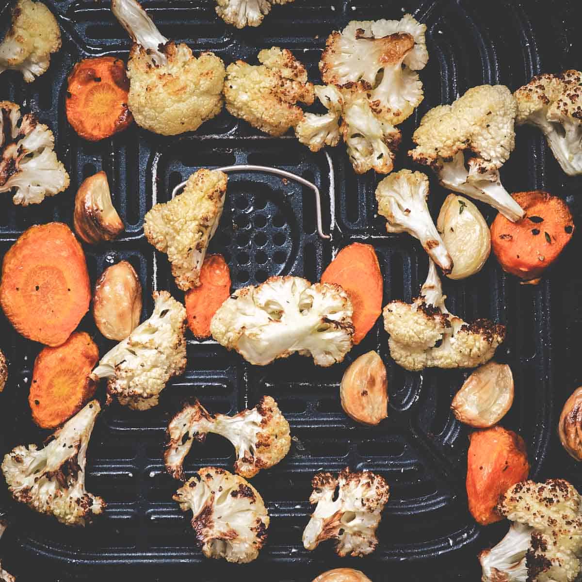 Roasting cauliflower and carrots in an air fryer.