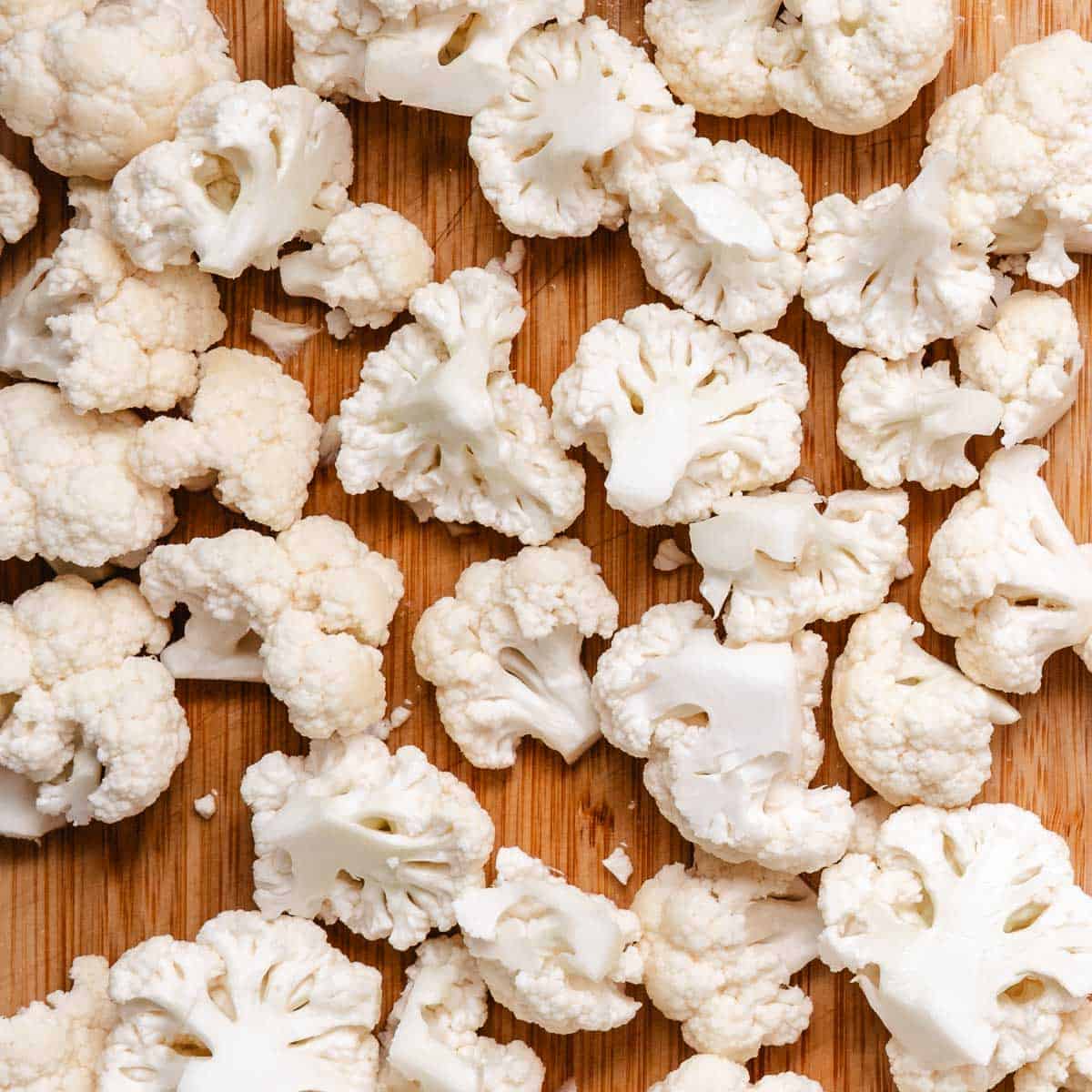 Chopped cauliflower on a cutting board.