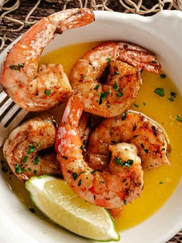 blackened shrimp with butter in a bowl.