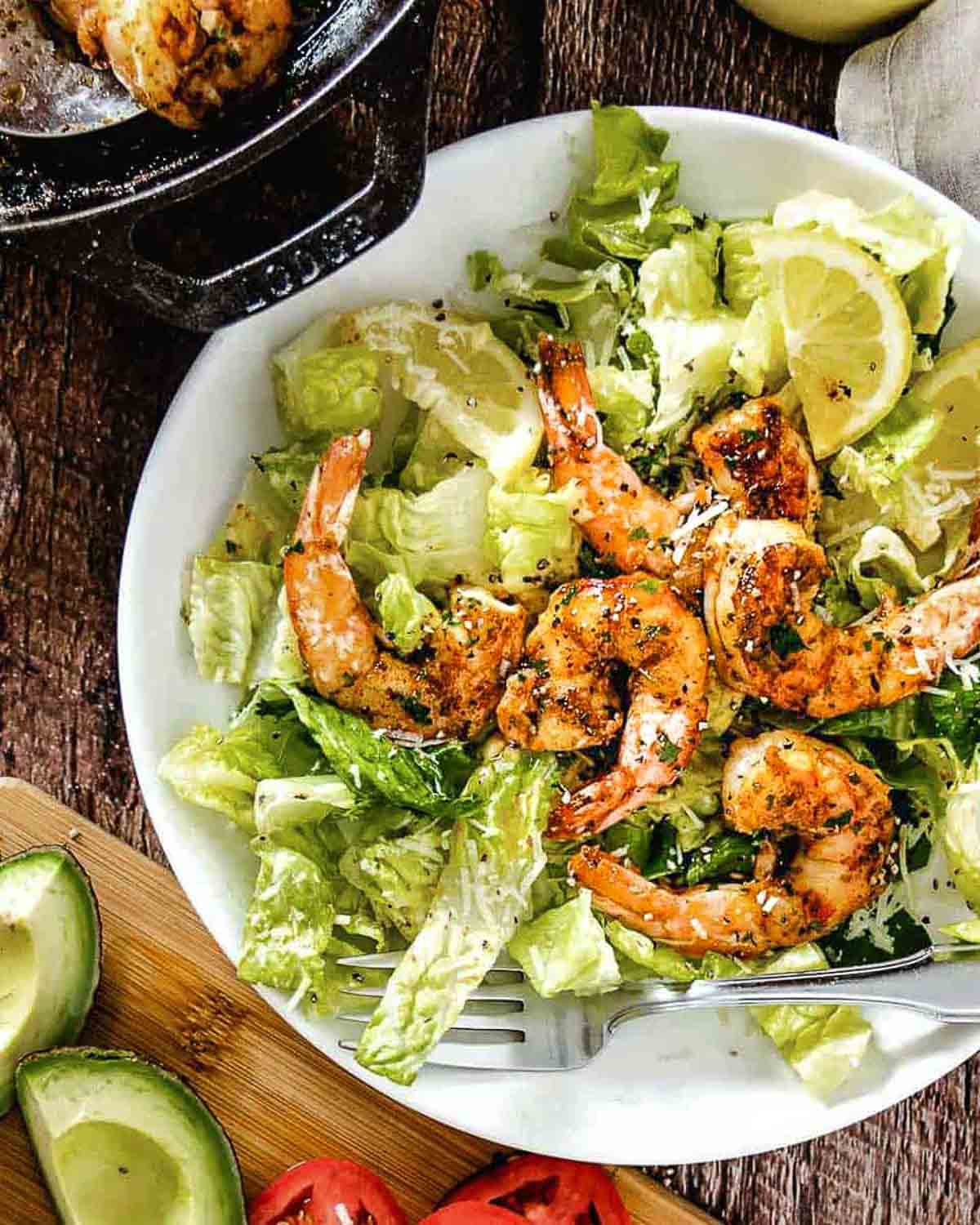 Caesar salad with shrimp on top.