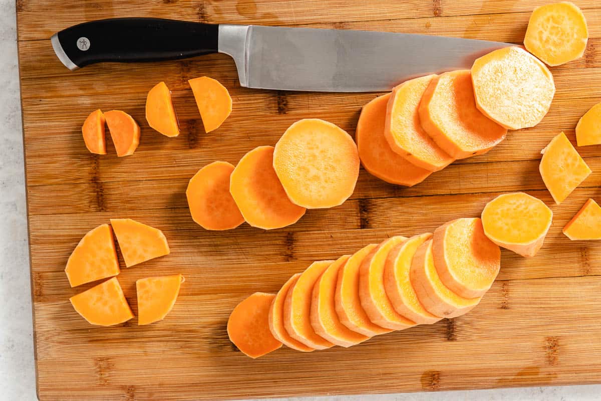 Cutting sweet potatoes on a board.