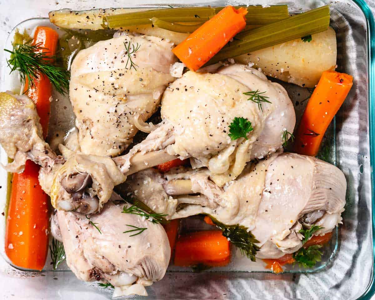 Cooked chicken pieces with carrots, celery, onion, and fresh herbs from homemade chicken soup