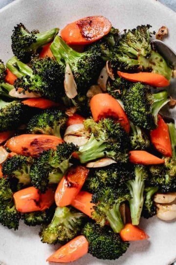 roasted broccoli, garlic, and carrots on a plate