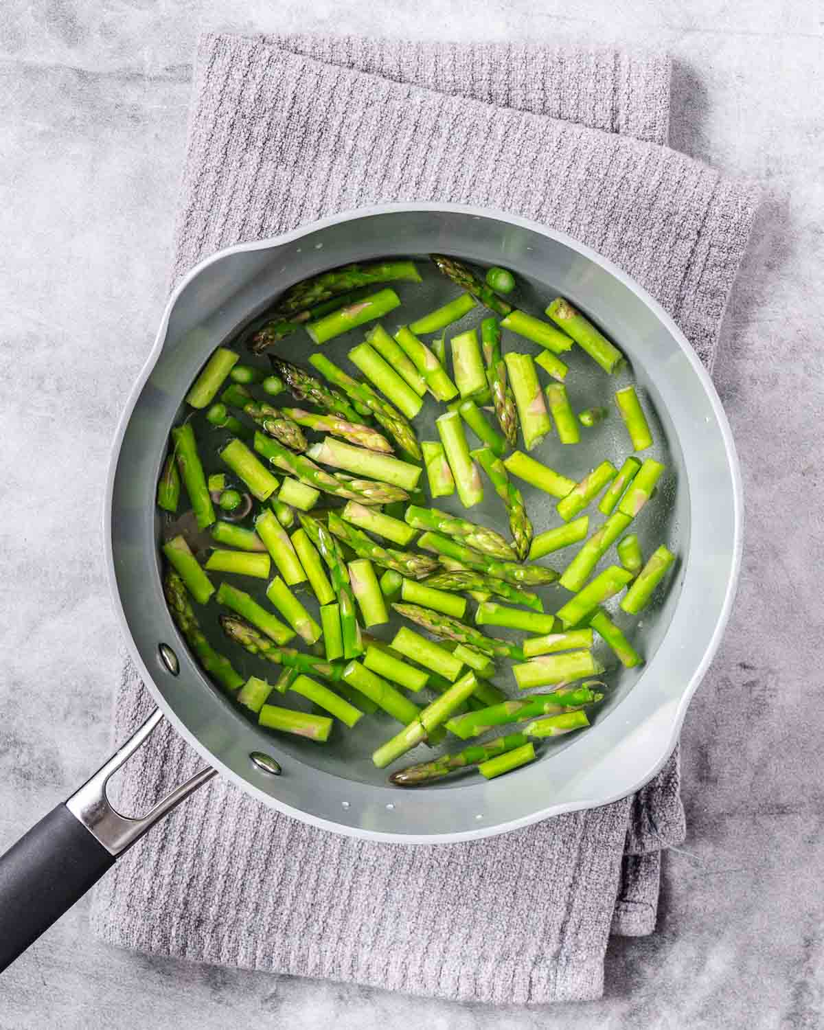 Boiling asparagus in saucepan.