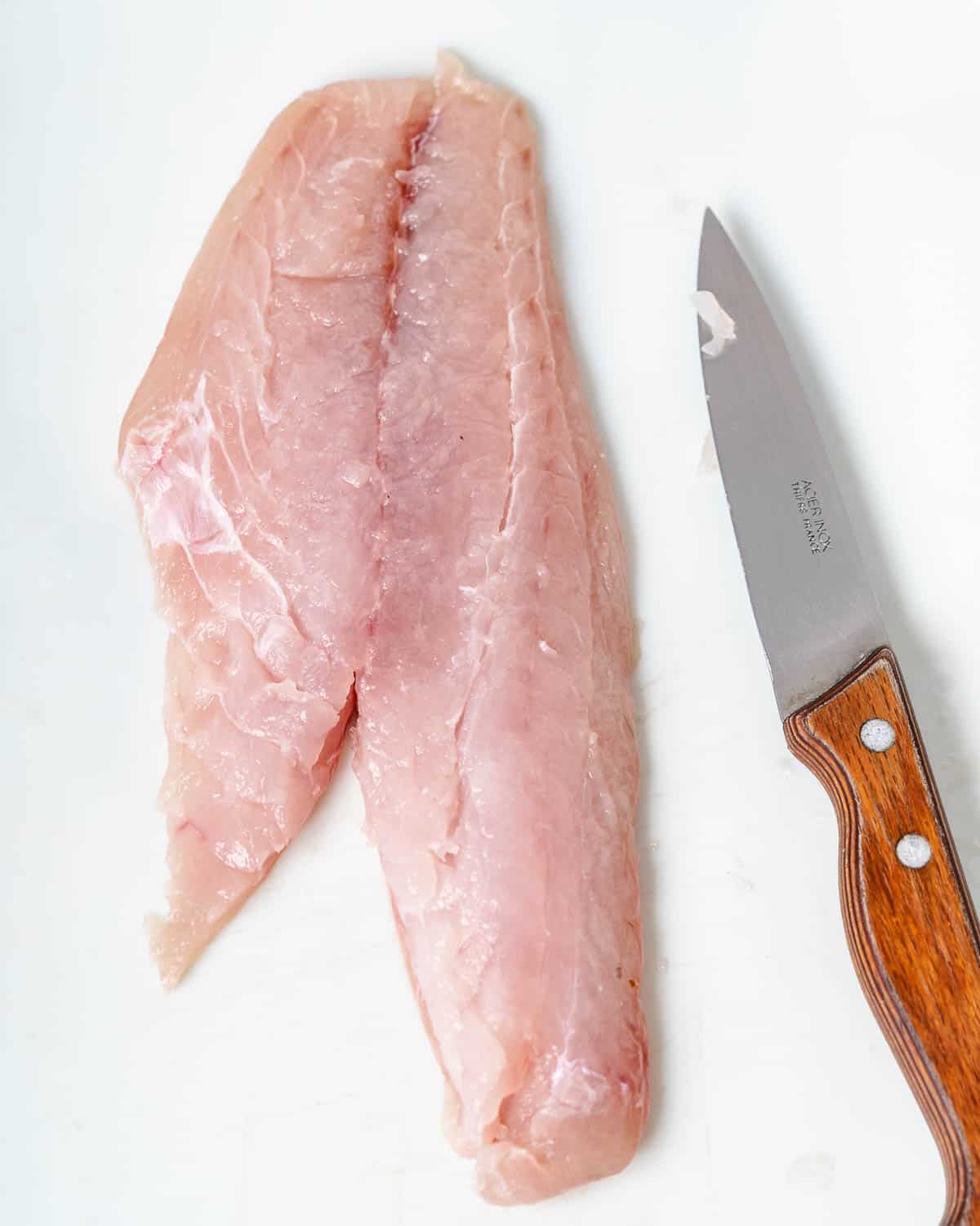 Fresh yellowtail with paring knife.