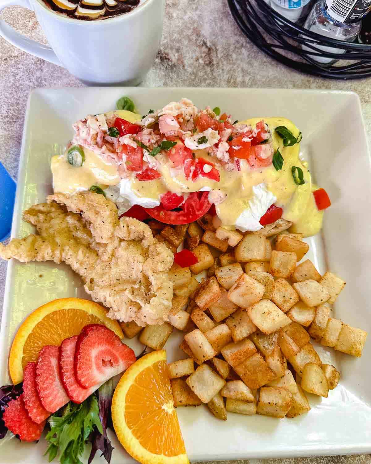 Eggs, conch and potatoes with orange and strawberry slices at Conch House Key Largo.