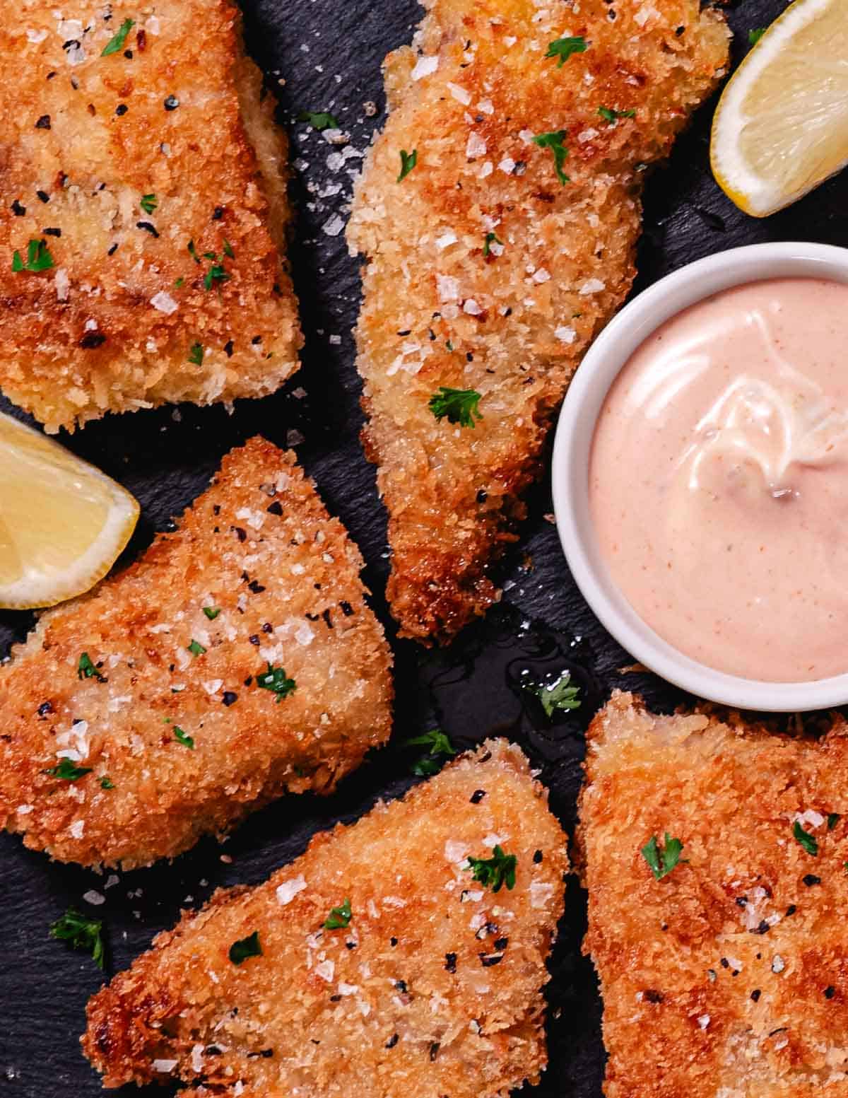 Crispy pan fried red snapper fillets with a golden panko crust, served with lemon wedges and dipping sauce