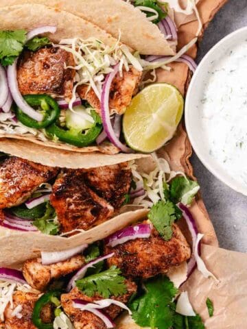 Red Snapper tacos with cilantro lime cream and cabbage.