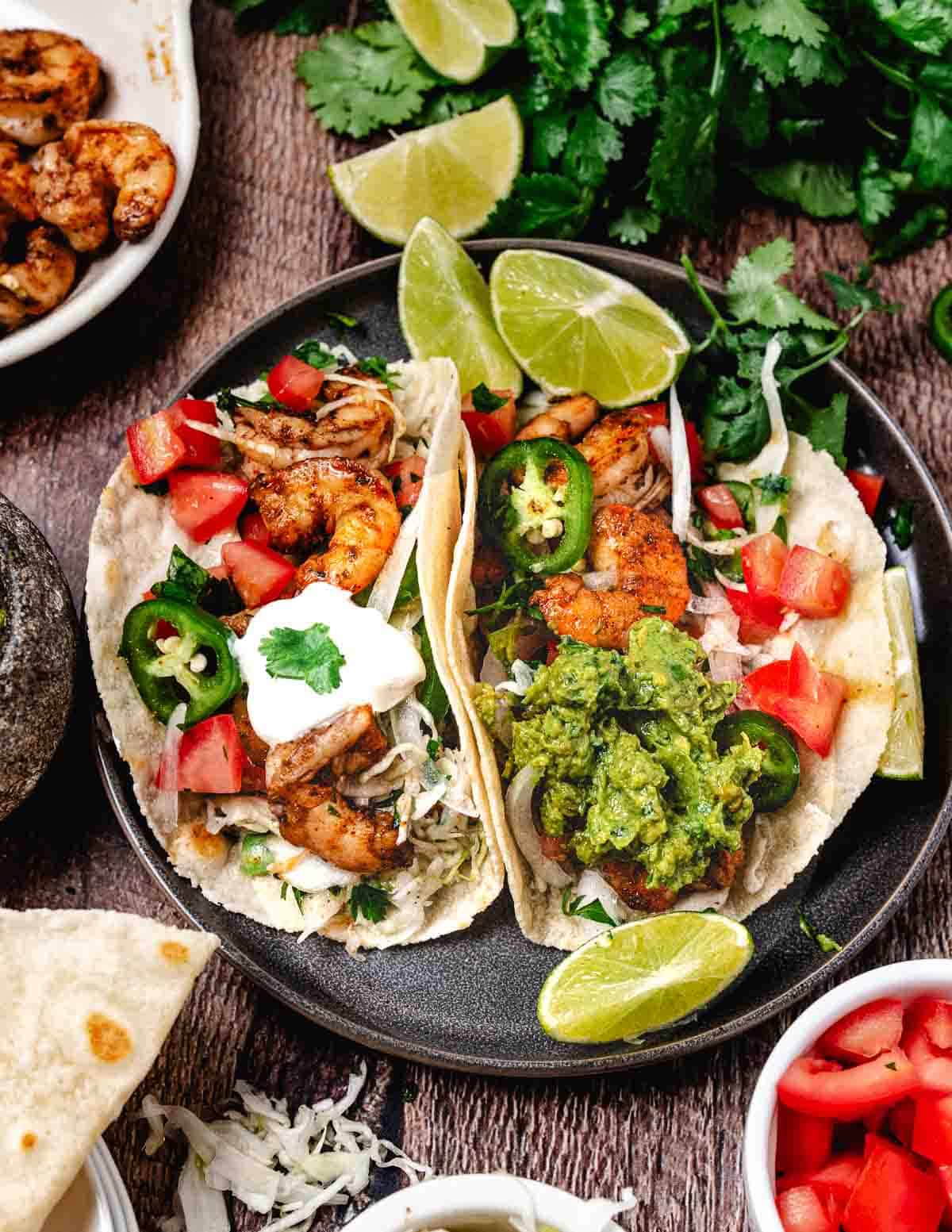 Healthy shrimp tacos with lime wedges.