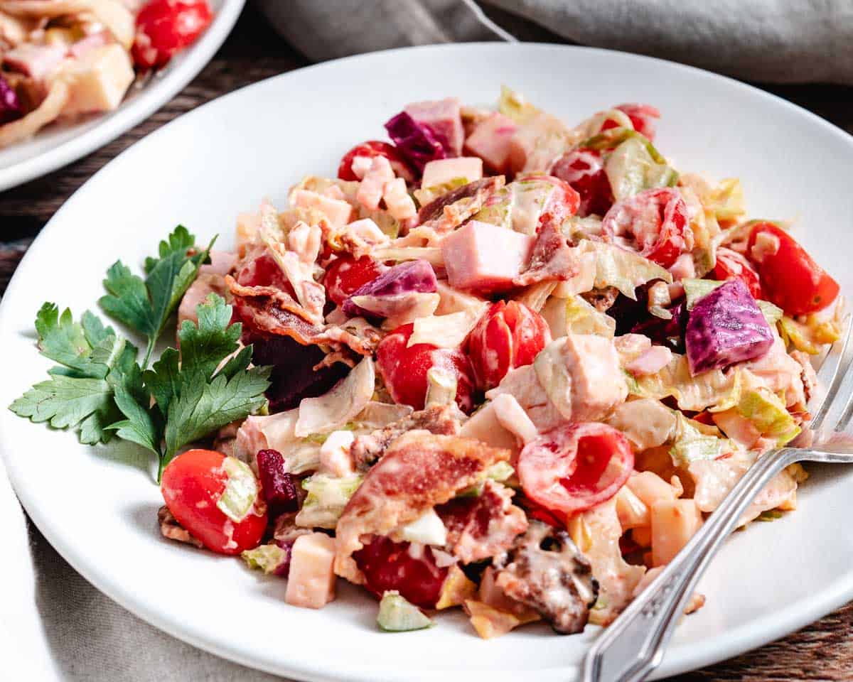 Gotham chopped salad on white plate.