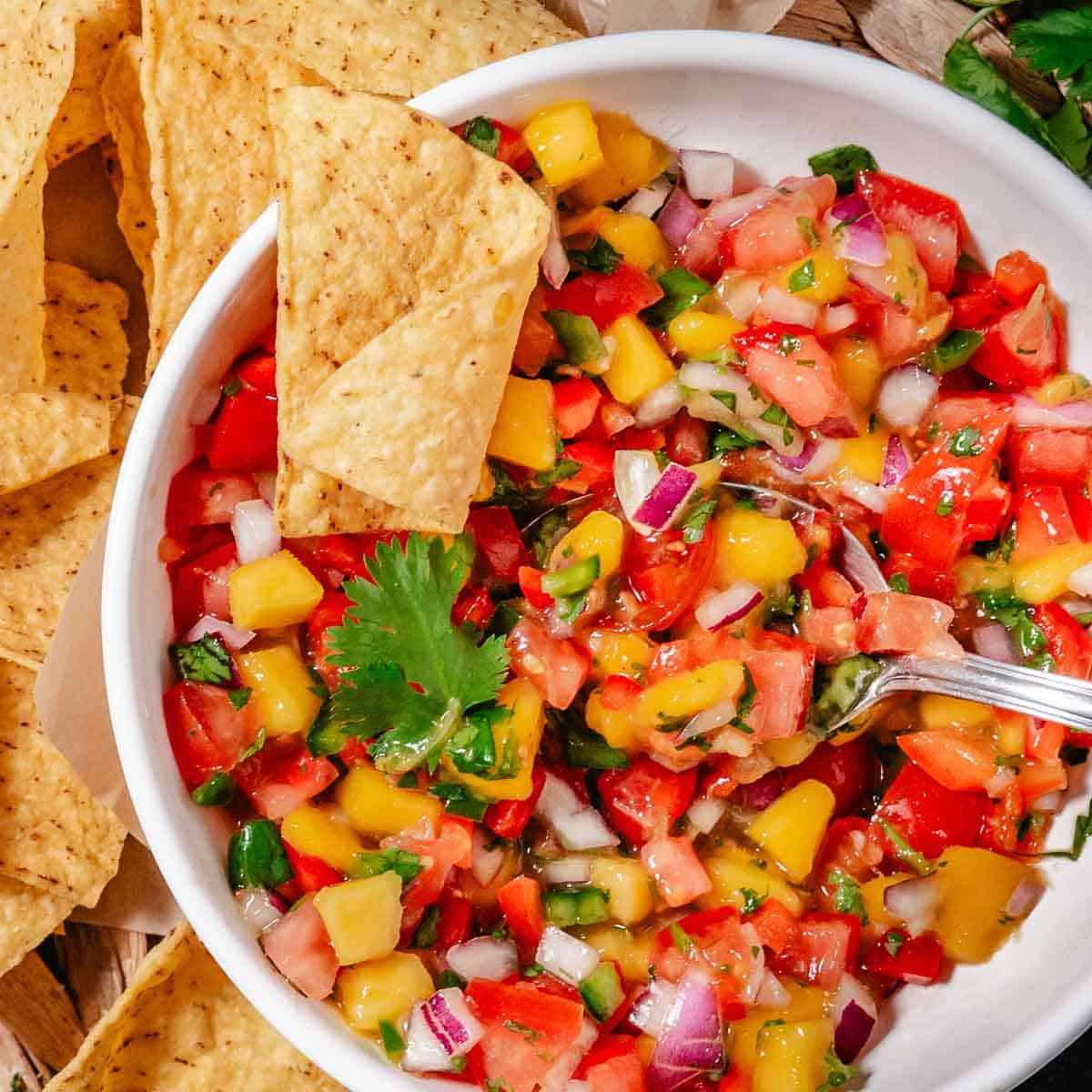 bowl of mango pico de gallo with tortilla chips