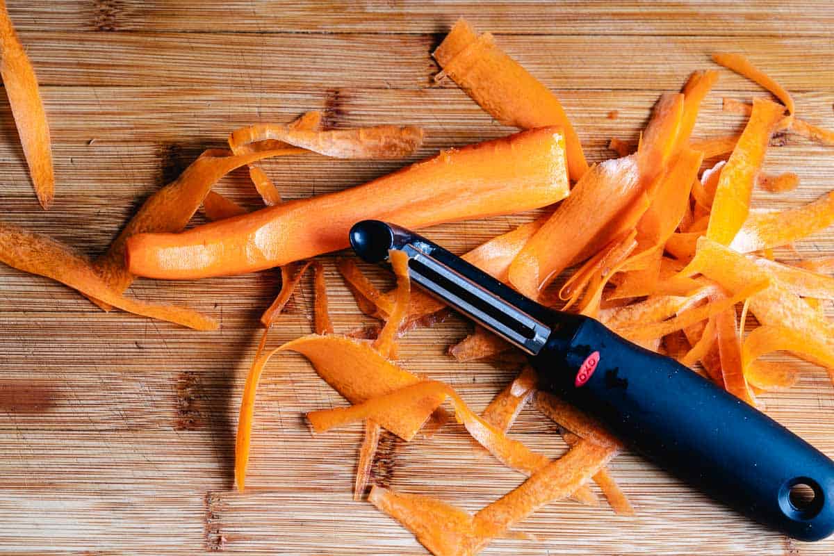 Peeling a carrot with a peeler.