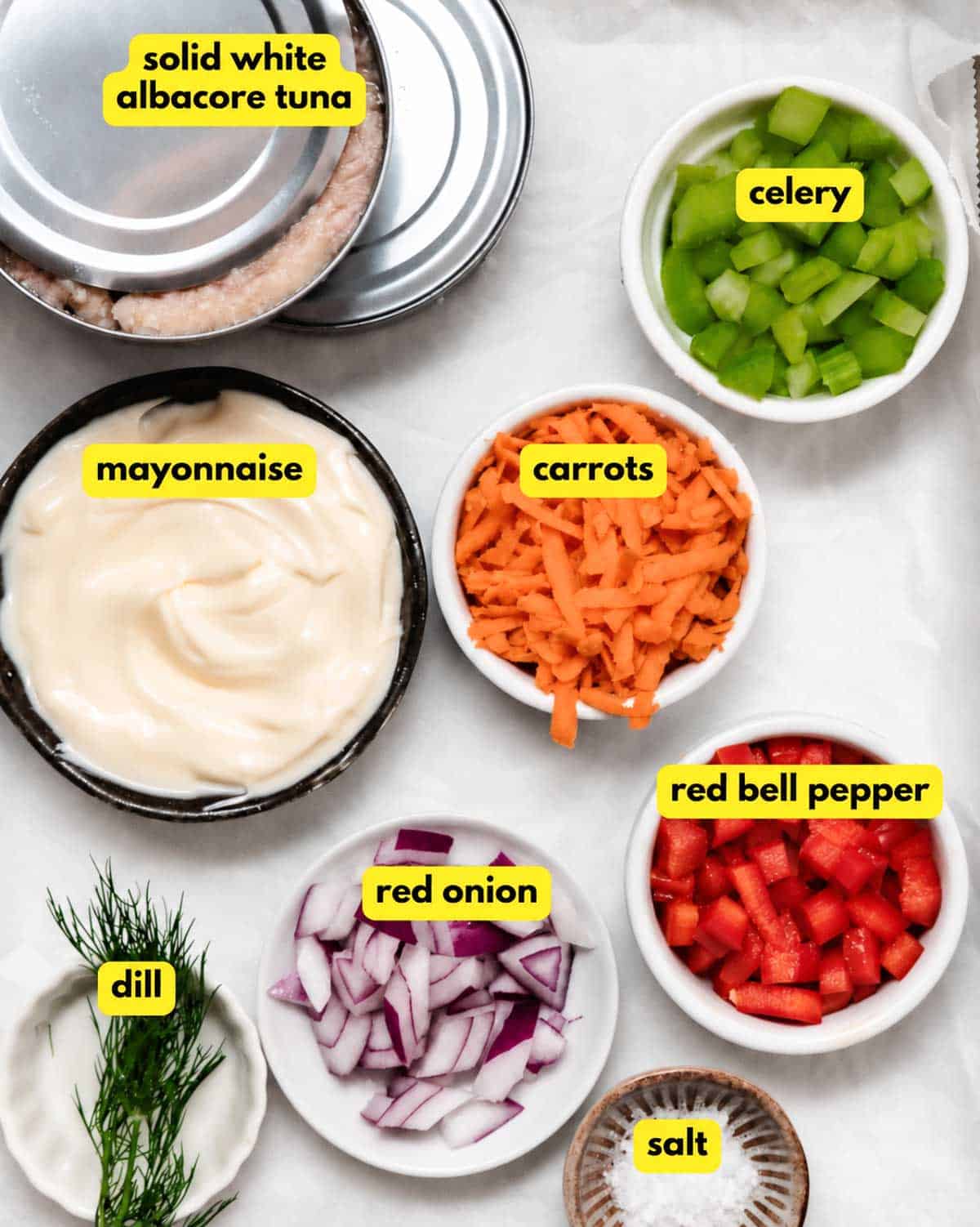 Ingredients for veggie tuna salad, including solid white albacore tuna, mayonnaise, carrots, celery, red bell pepper, red onion, dill, and salt
