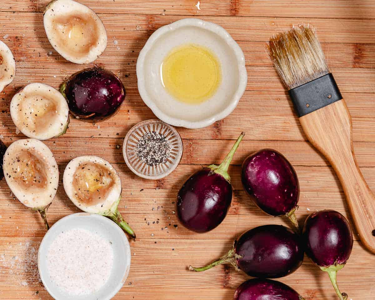 Baby eggplants, oil, salt, pepper, pastry brush.