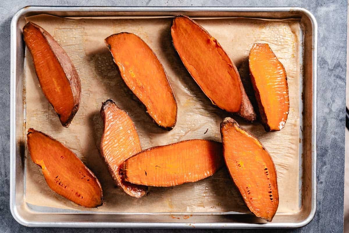 Sweet potato halves with pastry brush and oil.