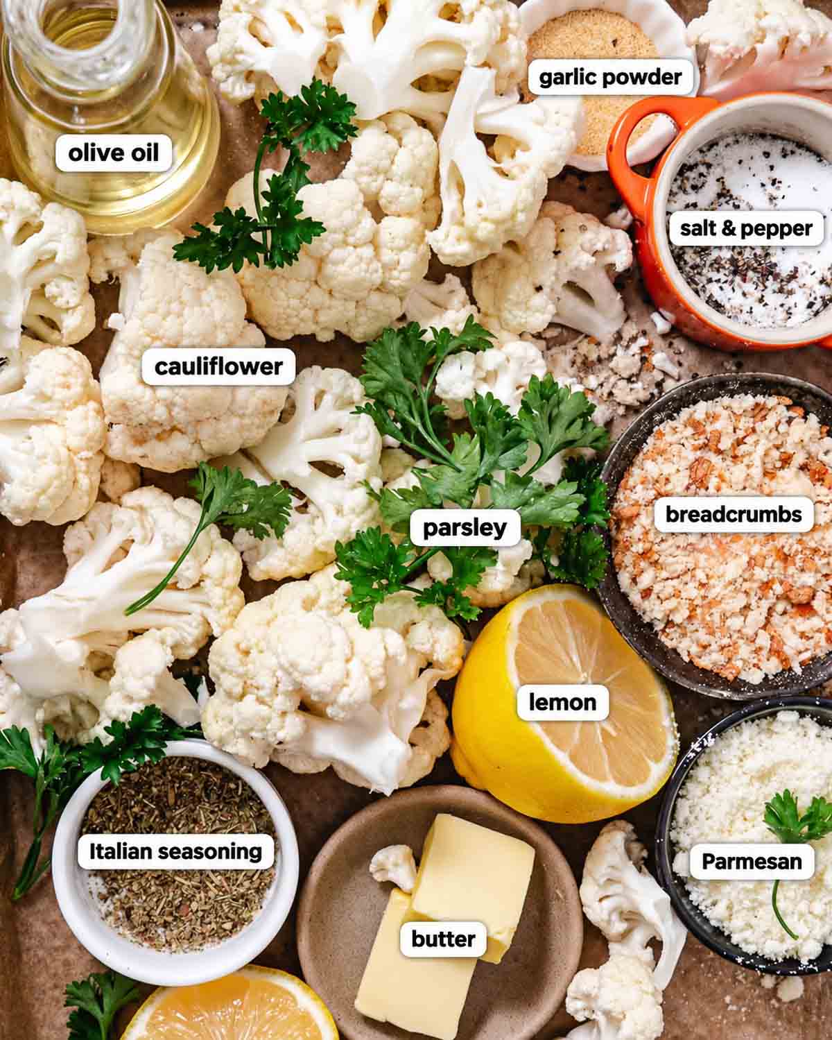 Labeled ingredients for roasted cauliflower with breadcrumbs, including cauliflower, olive oil, butter, Parmesan, lemon, parsley, and seasonings.