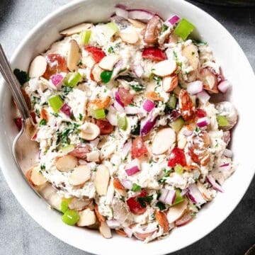 Bowl of chicken salad with grapes and almonds.