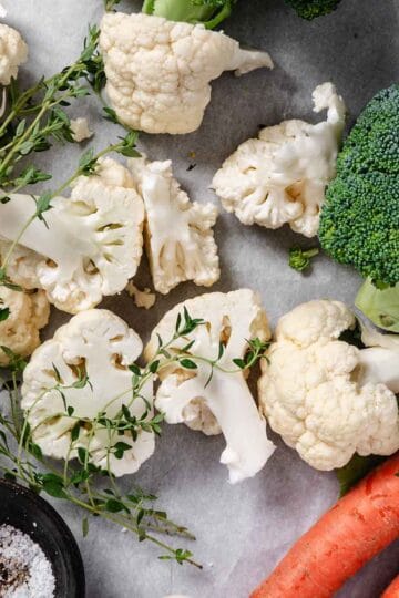 Fresh vegetables with herbs before roasting.