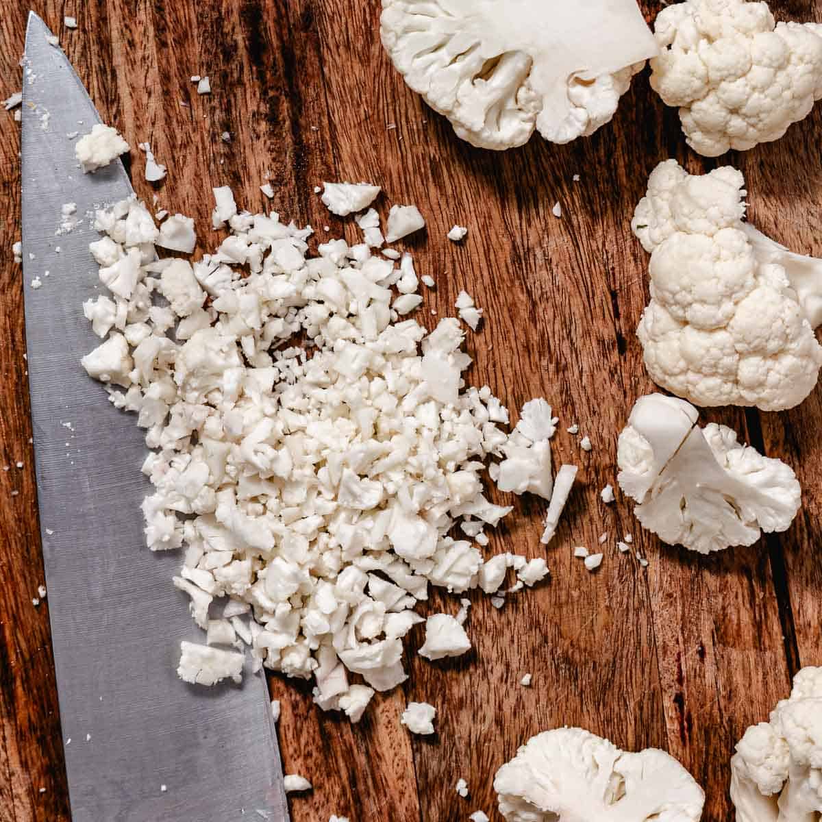 Chopping cauliflower into rice-sized pieces with a chef's knife