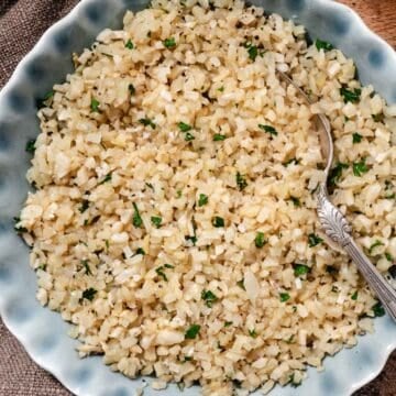 Cooked cauliflower rice in a serving bowl.