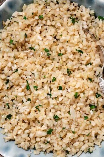 Cooked cauliflower rice in a serving bowl.
