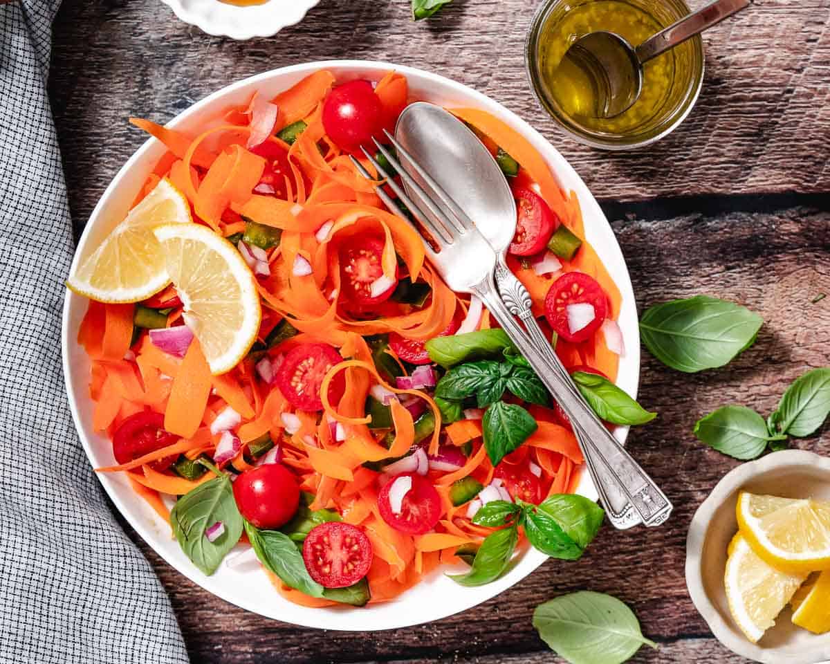 Italian style carrot salad with carrots, tomatoes, basil, and bell pepper.
