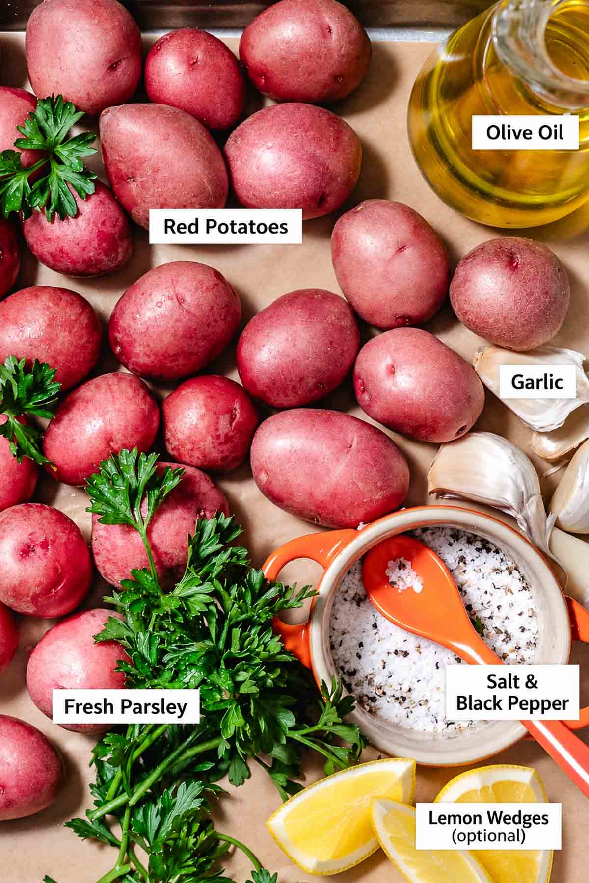 Ingredients for roasted red potatoes, including small red potatoes, olive oil, fresh parsley, garlic, salt, and black pepper.