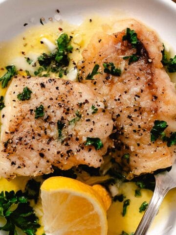 Cooked tripletail with garlic butter sauce.