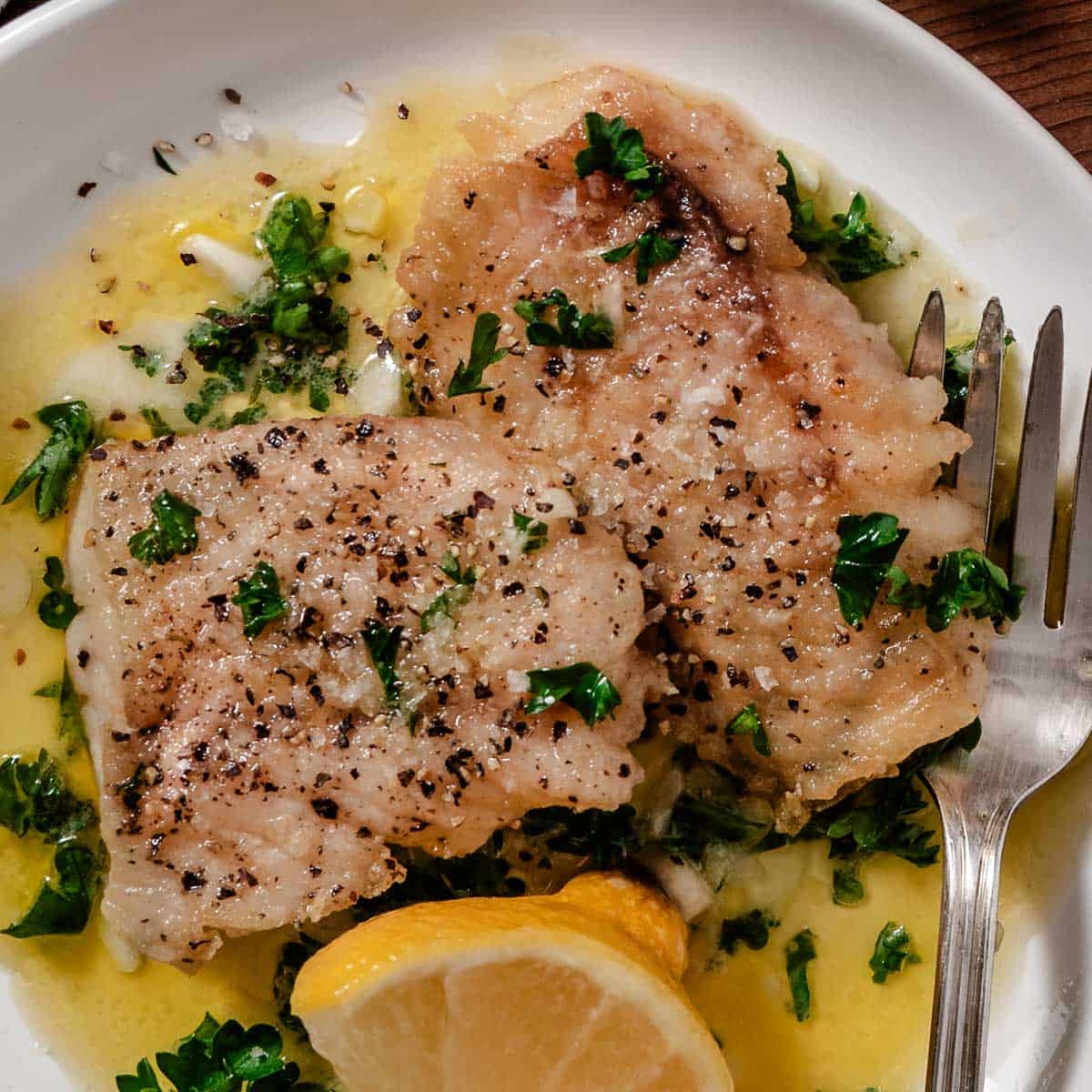 Tripletail fillet with lemon and butter sauce.