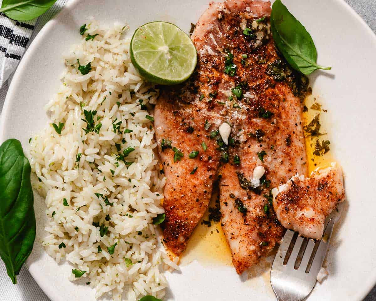 Blackened yellowtail fish with rice and lime.