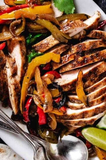 platter of chicken fajitas with tortillas and guacamole