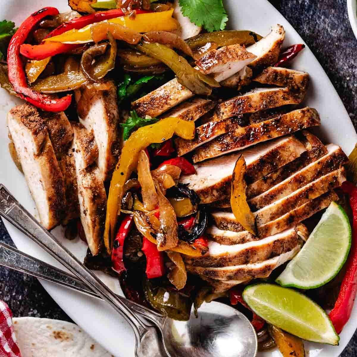 platter of chicken fajitas with tortillas and guacamole