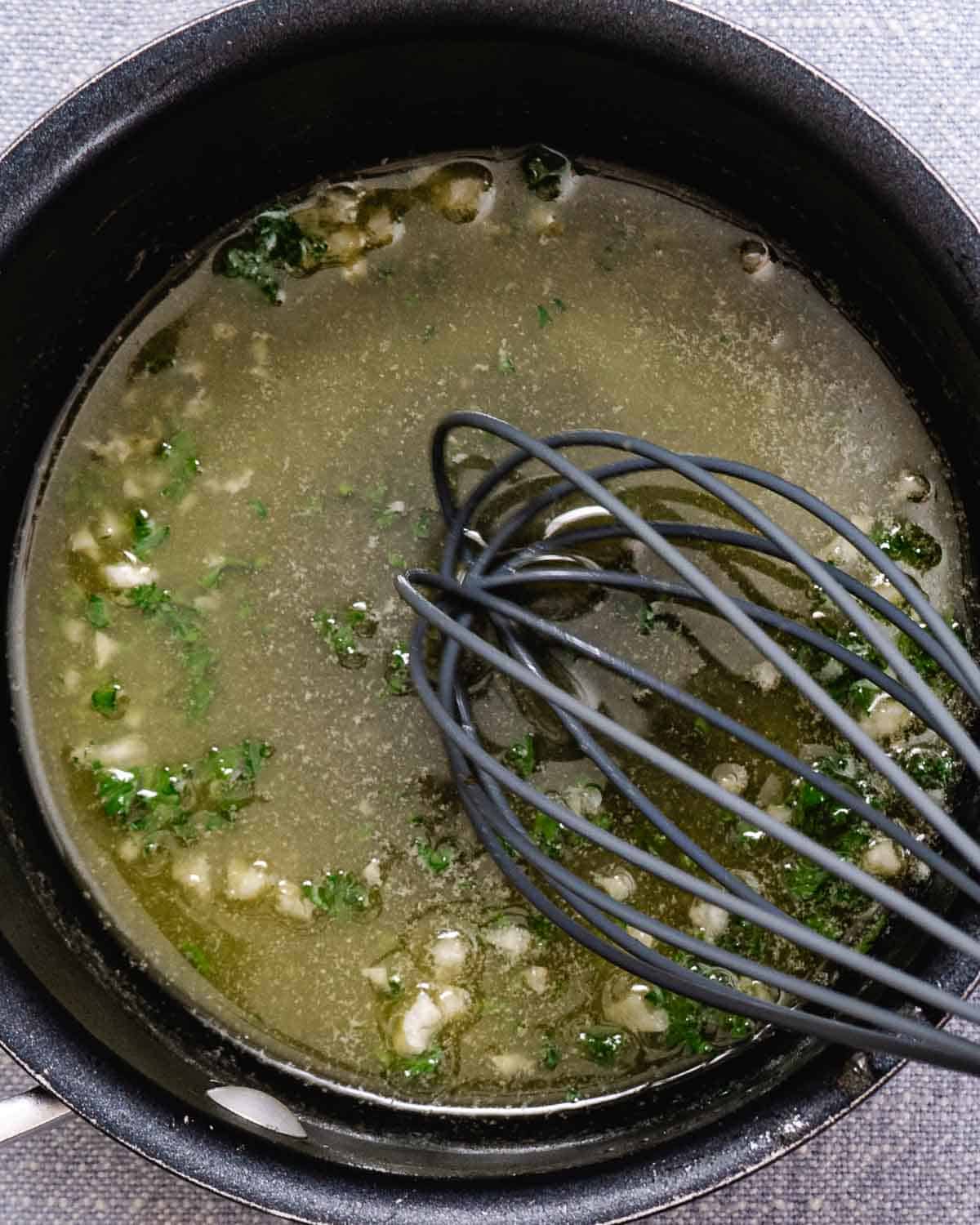 Warm the butter, garlic, lemon juice, and parsley for the lemon butter sauce.