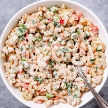 Macaroni salad in white bowl.