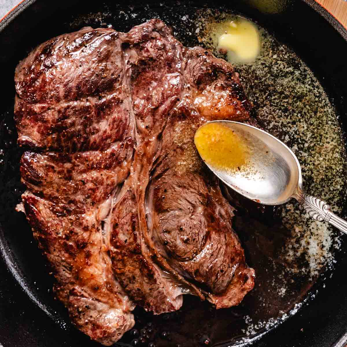Basting seared chuck steak with garlic butter