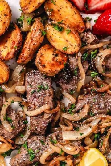 Sauteed liver and onions with strawberries and lemon.