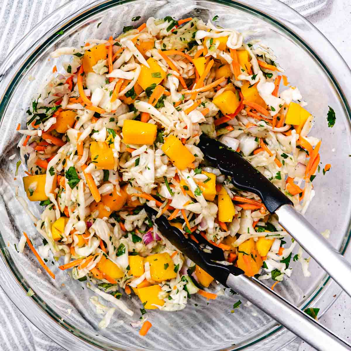 Glass bowl of mango coleslaw