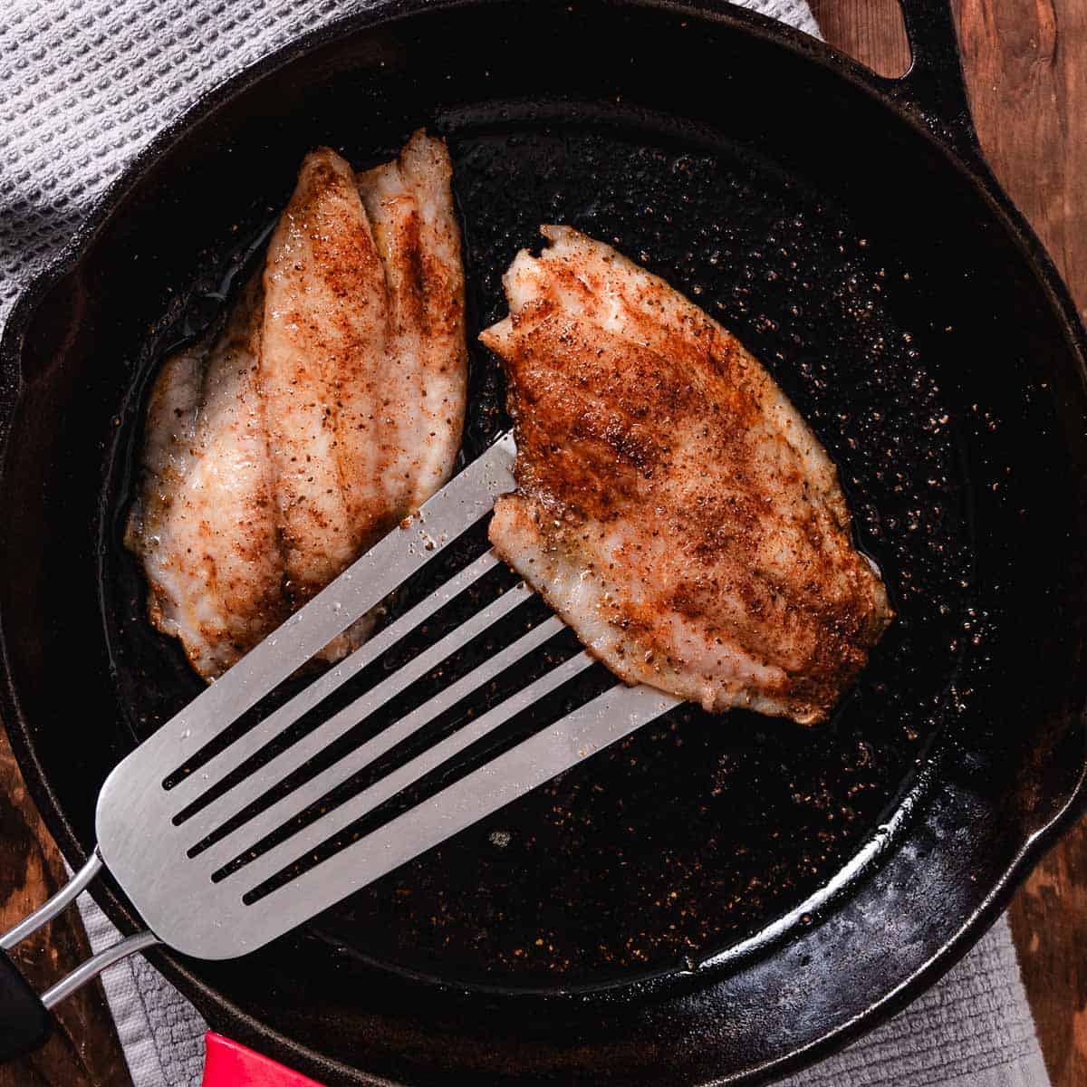 Cooking mangrove snapper in a cast iron pan.