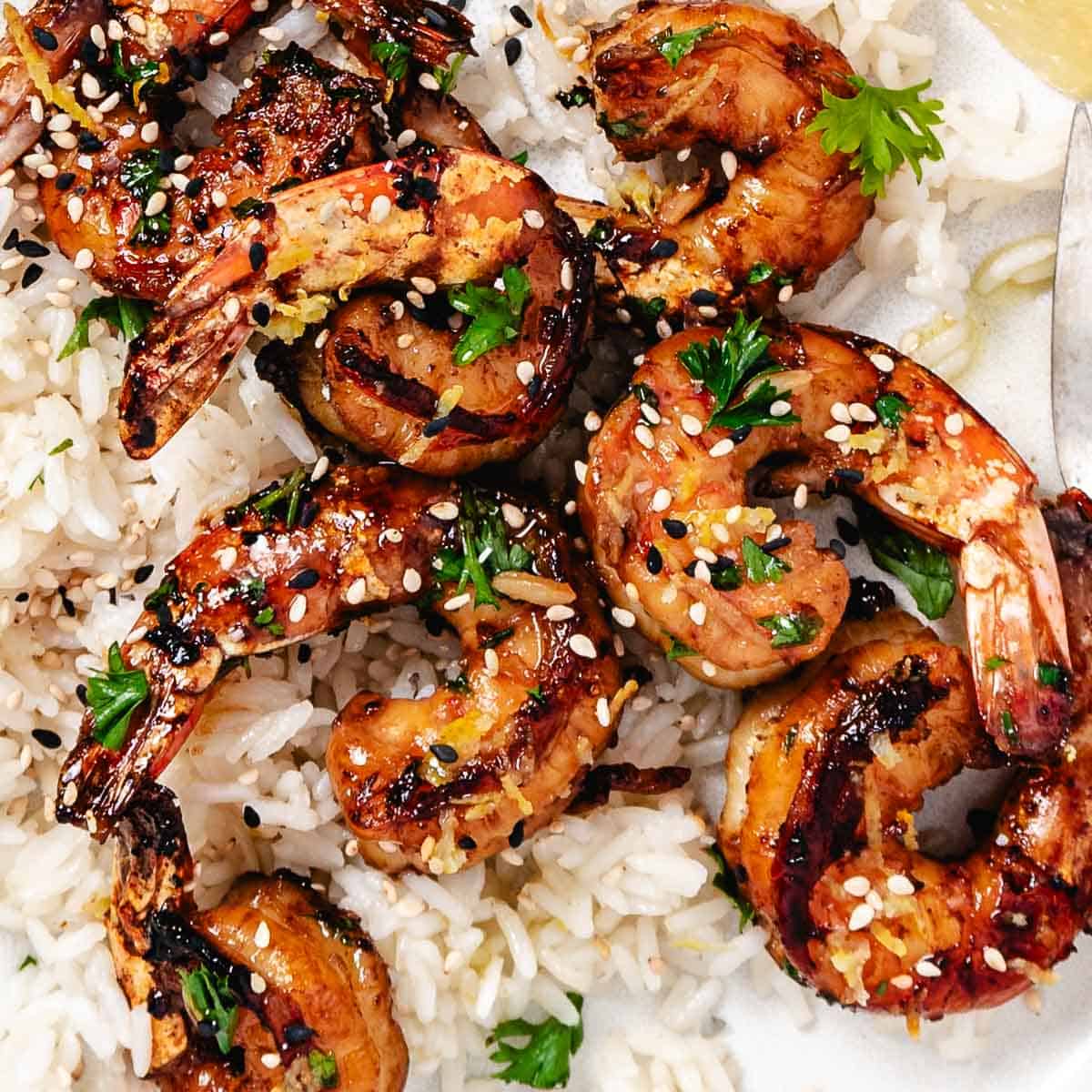 Sauteed shrimp with sesame seeds over rice.
